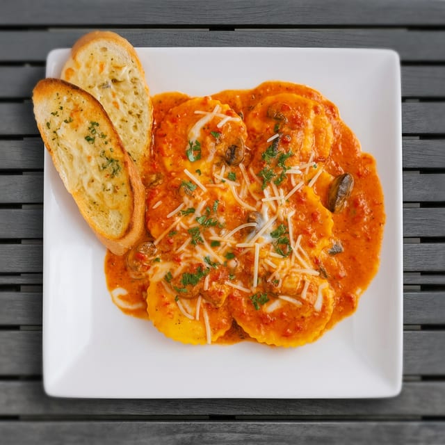 Jumbo cheese ravioli with roasted red pepper cream sauce.